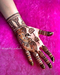 the hand is decorated with henna designs