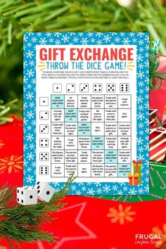 a printable christmas gift exchange game with dices and presents on the table next to it