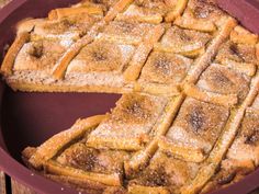 a pie that has been cut into pieces and is sitting in a pan on the table