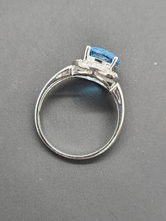 14k White Gold Fancy Cut Round Blue Topaz and Diamond Halo Ring Size 7 Appraisal Report Included Item w# 67 Clean and in good condition Ring can be sized by your local jeweler 2.80 ct Blue Topaz .12 cttw Diamonds Color I/J Clarity SI American Appraisal Association Estimated Retail value $695 Formal Fine Jewelry Topaz Princess Cut Ring, Formal Princess Cut Topaz Ring, Anniversary Topaz Ring In 14k White Gold, 14k White Gold Topaz Gemstone Ring For Anniversary, 14k White Gold Topaz Ring With Diamond Accents, Formal Emerald-cut Topaz Ring In 14k White Gold, Formal Blue Topaz Ring In White Gold, Formal Blue Topaz Ring With Accent Stones, Fine Jewelry Topaz Ring Baguette Cut