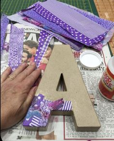 the letters are made out of scrap paper and fabric, along with other crafting supplies