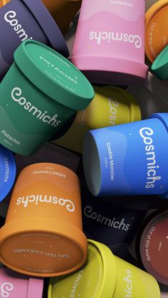 many different colored cups are stacked on top of each other with the word gourmet written on them