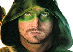 a man with green paint on his face wearing a hoodie and looking at the camera