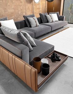 a living room filled with lots of gray couches