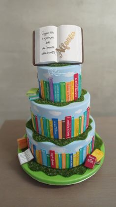 a cake made to look like a stack of books with a bookmark on top