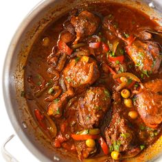 a pot filled with meat and vegetables on top of a table