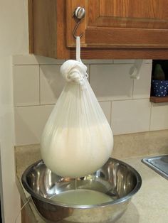 a large onion in a metal bowl on a counter