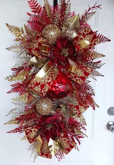 This Beautiful vibrant wreath is a must have for the holidays season ❤️ stuffed. Full with ornament, greenery,sprays and beautiful designer ribbons. This design can go great Christmas and all Year Round. ❤️💛 Gorgeous Red and gold door Swag. This wreath is perfect for all occasions and seasons. This wreath is perfect for Mantel and wall decor. Also a great gift for someone house warming. The wreath is perfect for indoors and outdoors use. **Please note, while the wreath in made to last the wreath is not intended for direct weather elements. Over time water can damage the wreath and the sun can fade the colors and decoration. Try to place your wreath in a protected area. Swag Wreaths For Front Door, Swag Christmas, Gold Door, Red Jewel, Wreath Door