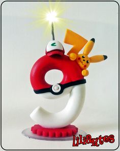 a pokemon figurine with pikachu and pokeball on top