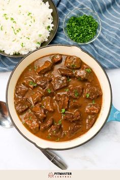 a bowl filled with meat and rice next to a spoon