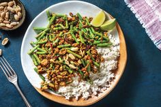 a white plate topped with rice and green beans