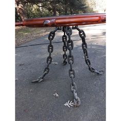 a wooden table with chains attached to it