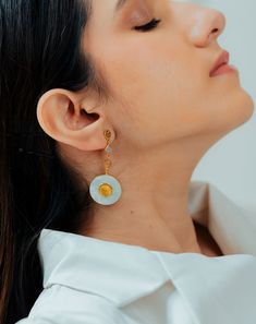 These beautiful earrings are inspired from architectural motifs found in palaces of Jaipur. Amber means sky in Sanskrit and other meaning of Amber is Yellow and Gold. Handcrafted using unique mother of pearl stones and citrine stone, set in modern silhouette. This is our take on festive modern jewelry. It is feather light in weight yet it is statement making. Posts of these earrings are in 925 Silver. Fusion Style White Earrings For Gifts, White Fusion Style Earrings For Gift, White Modern Pierced Pearl Earrings, Modern White Pierced Pearl Earrings, Modern White Mother Of Pearl Jewelry, Modern Mother Of Pearl Earrings For Gifts, Modern White Mother Of Pearl Earrings, Semi Precious Jewelry, Amber Earrings