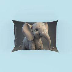 a pillow with an elephant sitting on it's side and the image is made out of paper