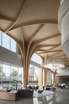 the lobby is very large and has high ceilings with curved wooden beams on each side