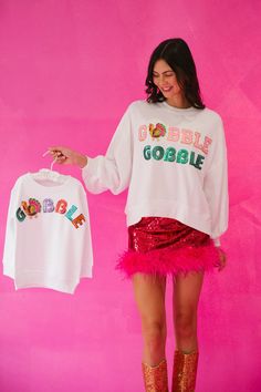 Show off your holiday spirit with this GOBBLE GOBBLE White Pullover! This lightweight cropped top is sure to get you in the Thanksgiving mood with its pink and green sequin Gobble Gobble text, and a feathered turkey patch sure to put a smile on your turkey-lovin' face. Feel cozy and festive all at once! Gobble 'til you wobble! This is a made-to-order item. All customized orders are currently shipping within 14 business days. To receive item quicker, expedited shipping is available at checkout. S Gobble Til You Wobble, White Pullover, Gobble Gobble, Green Sequins, White Design, Cropped Top, Holiday Spirit, Little One, Pink And Green