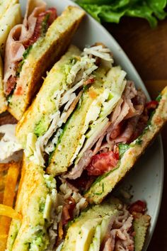 a sandwich cut in half sitting on top of a white plate