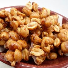 some nuts are sitting on a red plate