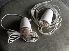 two white hair dryers sitting next to each other on top of a green rug