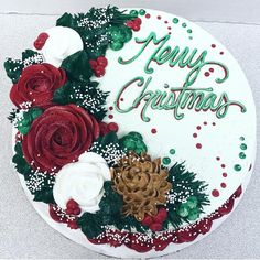 a decorated christmas cake with red and white flowers