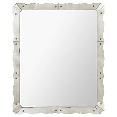 a square mirror with metal studding around the edges