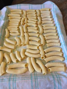 several rows of uncooked pasta on a towel