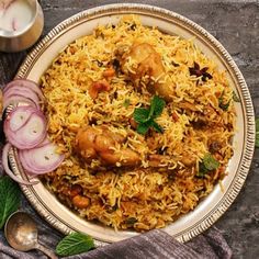 a white plate topped with rice and meat