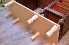 an old wooden bed frame with some white knobs on the top and bottom part