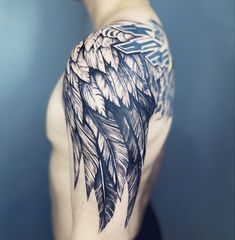 a man's half sleeve with feathers on it