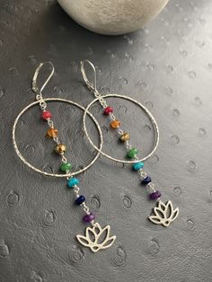 These dainty gemstone Chakra earring is designed with seven different gemstones, each symbolizing the seven energy points in your boyd. Each of the gemstones has its healing powers and is believed to render physical, mental, and spiritual benefits. From bottom to top, this strand includes Ruby, carnelian, pyrite, emerald, turquoise, lapis lazuli and amethyst. ---------------------------------------- *JEWELRY CARD OPTIONS* Please indicate your choice of a message or your personals message in the Multicolor Natural Stones Hoop Earrings As Gift, Multicolor Hoop Earrings With Natural Stones For Gift, Gift Multicolor Hoop Earrings With Natural Stones, Silver Dangle Hoop Earrings With Natural Stones, Silver Hoop Earrings With Natural Stones As Gift, Multicolor Gemstone Hoop Earrings For Gift, Chakra Jewelry Diy, Diy Gemstone Earrings, Chakra Lotus