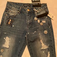 Denim Jean With Rips And Rhinestones And Has Some Splatter Paint . Brand New Never Worn Super Cute. Boyfriend Cut Trendy Mid-rise Rhinestone Jeans, Trendy Rhinestone Jeans, Casual Denim Blue Jeans With Rhinestones, Casual Denim Rhinestone Jeans, Medium Wash Rhinestone Denim Jeans, Trendy Embellished Denim Jeans, Casual Fitted Jeans With Rhinestones, Fitted Casual Jeans With Rhinestones, Casual Rhinestone Jeans