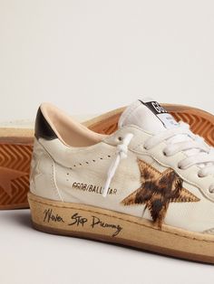 Dreaming of the Eighties. Our Ball Star sneakers have an American college vibe caught between a hoop shot and a skateboard ride. This version with a white nappa leather upper features a leopard-print pony skin star in shades of beige and brown, a black leather heel tab and a toe cap in ice-gray suede. The contrasting black Never Stop Dreaming lettering on the sole and the white laces add the finishing touch: beautiful things that never go out of fashion. Ugg Coquette, Golden Family, Stop Dreaming, Adidas Shoes Women, Never Stop Dreaming, Exclusive Sneakers, Shades Of Beige, Black Heel, Star Sneakers