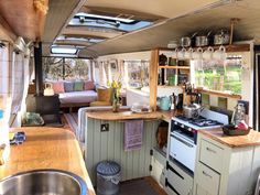 an rv kitchen and living room are shown in this view from the dining area to the outside