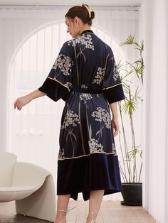 Experience the allure of Eastern luxury and elevate your everyday moments with this Luxury Velvet Kimono Robe for any occasion. Immerse yourself in the sumptuous feel of our ultra-soft, high-quality fabric, delicately adorned with stunning floral prints. - One size comfortably fits most- Up to 43" at chest and hips- A luxurious velvet robe with gold and black trim- Navy velvet with flower blossoms- Removable waist tie closure - Belt loops and inside ties to secure closure- Relaxed fit with sligh Elegant Blue Floral Print Kimono, Elegant Long Sleeve Gold Robe, Winter Robes, Velvet Kimono, Kimono Vintage, Velvet Clothes, Navy Velvet, Everyday Moments, Floral Kimono