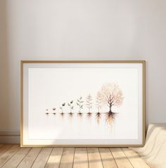 an art print with trees and birds reflected in the water on a wooden floor next to a white wall