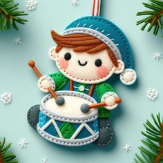 a christmas ornament with a boy playing the drums