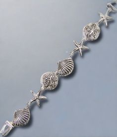 This Seashell Charm Bracelet is made of silver and features a magnetic closure, measuring 7 inches in length. It's lead and nickel free and consists of 7 pretty silver seashells. A must-have for any beach enthusiast. Beachy Anklets, Celebrity Style Jewelry, Flamingo Earrings, Cartilage Jewelry, Nose Hoop, Magnetic Bracelet, Body Piercing Jewelry, Anklet Jewelry, Christmas Jewelry