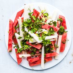 a white plate topped with watermelon and radishes