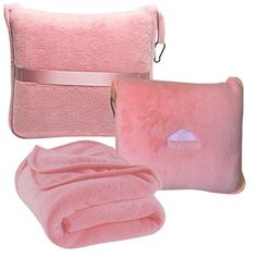 two pink towels, one with a pillow and the other with a blanket