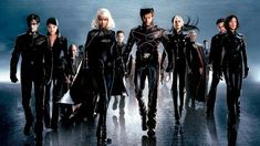 the x - men cast is standing in front of a dark background with their backs turned