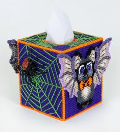 a close up of a tissue dispenser on a white background with spider webs