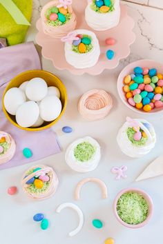 a table topped with lots of cakes and candy