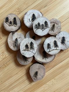 several pieces of wood that have been carved to look like pine trees with faces on them