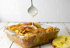 an apple cobbler being drizzled with milk