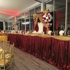 a banquet table set up with red and gold linens