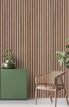 a green cabinet sitting next to a chair and potted plant on top of it