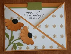 an envelope with flowers on it and a thank you note attached to the front side