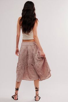 A true timeless staple, this sweet skirt is the perfect day-to-night piece. **Fit:** Mid-rise, billowy tiered fit **Features:** Elastic waist for pull-on ease, tiered trimming, side tie detailing, silky plisse fabrication **Why We ❤ It:** Elevated with sleek heels or unexpected with sporty sneakers, this style has endless ways to wear. | Maeve Midi Skirt by Free People in Tan, Size: M Feminine Tiered Bottoms With Layered Hem, Tiered Layered Hem Feminine Bottoms, Feminine Tiered Ruffled Skirt, Chic Relaxed Tiered Skirt, Tiered Bottoms With Layered Hem And Flowy Fit, Flowy Tiered Gathered Skirt Bottoms, Tiered Bottoms With Layered Hem, Tiered Layered Hem Bottoms, Flowy Tiered Feminine Skirt