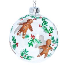 a glass ornament with gingerbreads and holly leaves on the bottom, hanging from a silver chain