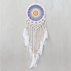 a multicolored dream catcher hanging on a wall